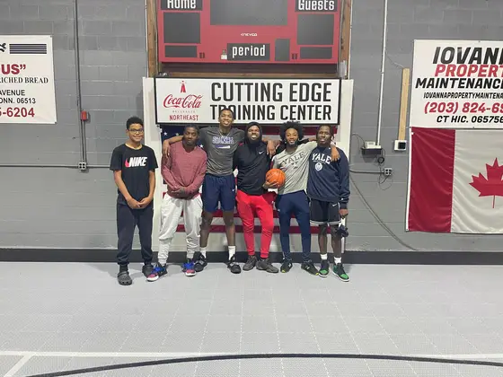 A group of young players under the Cutting Edge Training Center sign